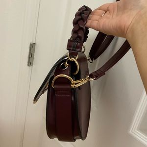 Maroon crossbody hand bag.